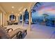 This outdoor covered patio has views of the pool, lush landscaping, and golf course in the background at 104 N Royal Ascot Dr, Las Vegas, NV 89144