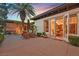 The open french doors from the patio lead to a dining room and a seating area at dusk at 104 N Royal Ascot Dr, Las Vegas, NV 89144