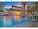 Luxury pool with waterfall features and mermaid statue, surrounded by palm trees and outdoor seating at 104 N Royal Ascot Dr, Las Vegas, NV 89144