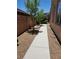 Gravel walkway between house and brick wall is the low maintenance backyard feature at 11005 Edina Ct, Las Vegas, NV 89144