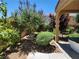 Picturesque backyard featuring green grass, landscaping, and a partially covered patio at 11005 Edina Ct, Las Vegas, NV 89144
