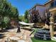 A landscaped backyard, complete with a hammock, small trees, grass, and rocks at 11005 Edina Ct, Las Vegas, NV 89144