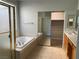 Bright bathroom featuring a soaking tub, a glass-enclosed shower, and a vanity sink with ample countertop space at 11005 Edina Ct, Las Vegas, NV 89144