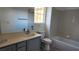 Bathroom featuring double sinks, tile surround, large mirror and natural light from the window at 11005 Edina Ct, Las Vegas, NV 89144