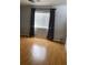 Bedroom with wood-look flooring, large window, and modern curtains for added privacy at 11005 Edina Ct, Las Vegas, NV 89144