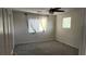 Bedroom featuring carpeting, a ceiling fan, and two windows providing natural light at 11005 Edina Ct, Las Vegas, NV 89144