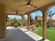 View of the covered patio with ceiling fans and a well manicured backyard at 11005 Edina Ct, Las Vegas, NV 89144