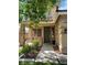 Inviting front entrance with a covered porch, complemented by tasteful landscaping and window details at 11005 Edina Ct, Las Vegas, NV 89144