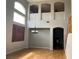 Spacious living area with archways, wood floors, tall windows, and a hanging light fixture at 11005 Edina Ct, Las Vegas, NV 89144