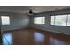 Spacious living room with wood-look flooring, ceiling fan and view of the backyard at 11005 Edina Ct, Las Vegas, NV 89144