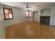 Cozy living room with a fireplace, shuttered windows, and a ceiling fan at 11005 Edina Ct, Las Vegas, NV 89144