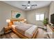 Cozy bedroom features a ceiling fan, natural light, and comfortable decor at 1313 Andrew David Ave, North Las Vegas, NV 89086