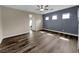 This large bedroom features wood-look floors and a modern ceiling fan at 1313 Andrew David Ave, North Las Vegas, NV 89086