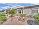 Well-manicured backyard features desert plants and small bridge, enhancing outdoor appeal at 2167 Fairweather St, Henderson, NV 89052