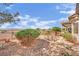 Landscaped backyard features desert plants and small bridge, perfect for enjoying the outdoors at 2167 Fairweather St, Henderson, NV 89052