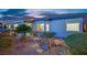Well-maintained backyard with desert landscaping, a charming wooden bridge, and a cozy covered patio at 2167 Fairweather St, Henderson, NV 89052