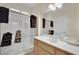 Bathroom featuring tile flooring, glass shower, bright lighting, and wood cabinets at 2167 Fairweather St, Henderson, NV 89052