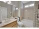 Well-lit bathroom with a tub, shower, vanity, decorative wallpaper, and neutral finishes at 2167 Fairweather St, Henderson, NV 89052