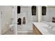 Bathroom with tiled floor, glass shower, bright lighting, and wood cabinets at 2167 Fairweather St, Henderson, NV 89052