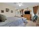 Spacious bedroom featuring a comfortable bed, accent furniture, carpet flooring, and natural light at 2167 Fairweather St, Henderson, NV 89052
