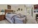 Comfortable bedroom with a decorative wooden headboard, sitting area, and carpeted floors at 2167 Fairweather St, Henderson, NV 89052