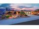Stunning single-story home featuring beautiful desert landscaping with walkway and well-lit exterior at dusk at 2167 Fairweather St, Henderson, NV 89052