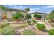 Lush landscaping frames the home, enhancing its curb appeal and creating a welcoming entrance at 2167 Fairweather St, Henderson, NV 89052