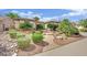 Beautifully landscaped front yard with mature trees and greenery providing a serene and inviting atmosphere at 2167 Fairweather St, Henderson, NV 89052