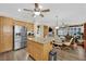 Spacious kitchen flows into the living room, with an island, stainless appliances, and seating at 2167 Fairweather St, Henderson, NV 89052
