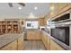 Kitchen with a view to the backyard with stainless appliances and natural wood cabinets at 2167 Fairweather St, Henderson, NV 89052
