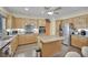 Well-equipped kitchen featuring stainless steel appliances, an island, and custom cabinetry at 2167 Fairweather St, Henderson, NV 89052