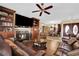 Cozy living room with a fireplace, built-in bookshelves, and adjacent dining area at 2167 Fairweather St, Henderson, NV 89052