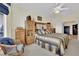 Cozy primary bedroom with ceiling fan, soft carpet, and neutral decor exudes a comforting ambiance at 2167 Fairweather St, Henderson, NV 89052