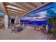 Charming covered patio boasts comfortable seating, dining area, desert landscaping and mountain views at 2167 Fairweather St, Henderson, NV 89052