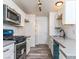 Galley kitchen featuring white cabinets, subway tile backsplash, and stainless steel appliances at 2200 S Fort Apache Rd # 2023, Las Vegas, NV 89117