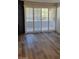 Open living room with wood flooring and sliding door to balcony provides a serene and inviting atmosphere at 2200 S Fort Apache Rd # 2023, Las Vegas, NV 89117