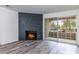 Living room with sliding doors to a patio and decorative fireplace at 2200 S Fort Apache Rd # 2023, Las Vegas, NV 89117
