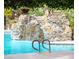 Community pool with an artificial stone waterfall feature, and clear blue water provides a picturesque and calming atmosphere at 2200 S Fort Apache Rd # 2023, Las Vegas, NV 89117