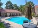 Community pool features a sun deck, tables with umbrellas, and lounge chairs to enjoy the outdoors in comfort at 2200 S Fort Apache Rd # 2023, Las Vegas, NV 89117