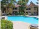 Inviting community pool offers a relaxing escape with lounge chairs, tables, and lush greenery providing a serene environment at 2200 S Fort Apache Rd # 2023, Las Vegas, NV 89117