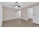 The bedroom features a ceiling fan, wood-look flooring, and an attached bathroom at 255 N Lamb Blvd # F, Las Vegas, NV 89110