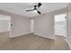 Bedroom with wood flooring, ceiling fan, and multiple doors leading to other rooms at 255 N Lamb Blvd # F, Las Vegas, NV 89110