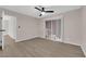 Spacious bedroom with wood flooring, ceiling fan, and sliding glass door access to the patio at 255 N Lamb Blvd # F, Las Vegas, NV 89110