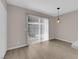 Bright dining area features sliding glass doors and modern lighting fixtures for a cozy atmosphere at 255 N Lamb Blvd # F, Las Vegas, NV 89110