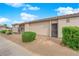 Single-story home featuring a stucco exterior, desert landscaping, and a tiled roof on a sunny day at 255 N Lamb Blvd # F, Las Vegas, NV 89110