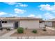 Cozy single-story home featuring a stucco exterior, desert landscaping, and a tile roof against a blue sky at 255 N Lamb Blvd # F, Las Vegas, NV 89110