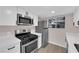 Modern kitchen design with stainless appliances, including a gas range, and white cabinetry at 255 N Lamb Blvd # F, Las Vegas, NV 89110
