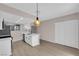 Open kitchen boasts stainless appliances, white cabinets, and a dining area at 255 N Lamb Blvd # F, Las Vegas, NV 89110