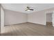 Spacious living room with stylish wood-look flooring, ceiling fan, and ample natural light at 255 N Lamb Blvd # F, Las Vegas, NV 89110