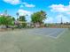 Outdoor tennis court area with basketball hoop surrounded by a fence and shade trees at 255 N Lamb Blvd # F, Las Vegas, NV 89110